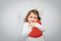 Young girl holding a plush red heart Royalty Free Stock Photo